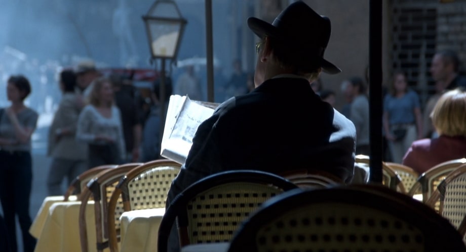 PAZZI SPIES ON LECTER IN A STREET CAFE