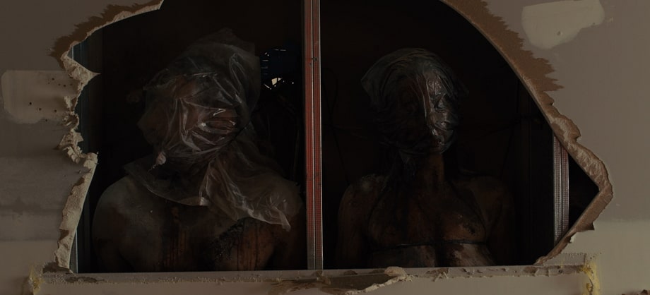 The dead bodies in the walls in the opening scene of Sicario